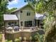 Back of house featuring wooden deck, lush foliage, and grey siding at 3125 Privateer Creek Rd, Seabrook Island, SC 29455