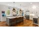 Spacious kitchen featuring a large center island, white cabinets, and modern stainless appliances at 3125 Privateer Creek Rd, Seabrook Island, SC 29455