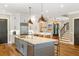 Open-concept kitchen boasts granite countertops, a central island, and stainless steel appliances at 3125 Privateer Creek Rd, Seabrook Island, SC 29455