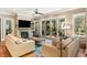 Comfortable living room with fireplace, hardwood floors, and access to an outdoor patio through sliding doors at 3125 Privateer Creek Rd, Seabrook Island, SC 29455