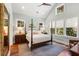 Serene main bedroom with high ceilings, a four-poster bed, and natural light from multiple windows at 3125 Privateer Creek Rd, Seabrook Island, SC 29455