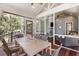 Inviting screened porch with dining and seating areas, perfect for enjoying the outdoors at 3125 Privateer Creek Rd, Seabrook Island, SC 29455