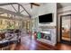 Cozy screened porch with a fireplace, comfortable seating, and a view of the lush backyard at 3125 Privateer Creek Rd, Seabrook Island, SC 29455