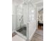 Modern glass-enclosed shower with subway tile surround and a view into the main bedroom at 3125 Privateer Creek Rd, Seabrook Island, SC 29455
