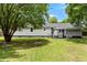 Spacious backyard with a well-maintained lawn, shade trees, a gazebo and the rear of the house at 3284 Sassy Dr, Johns Island, SC 29455
