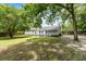 View of backyard with a lush lawn, shade trees, a gazebo, and partial view of the house at 3284 Sassy Dr, Johns Island, SC 29455