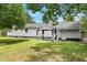Landscaped backyard with healthy grass, trees, the back of the house and a gazebo at 3284 Sassy Dr, Johns Island, SC 29455