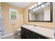 Well-lit bathroom featuring a vanity, toilet, decorative mirror, and tiled shower/tub at 3284 Sassy Dr, Johns Island, SC 29455