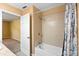 Tiled shower and tub in bathroom with open doorway showing access to the hallway at 3284 Sassy Dr, Johns Island, SC 29455