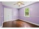 Empty bedroom with purple walls, wood floors, a ceiling fan, and a window that provides natural light at 3284 Sassy Dr, Johns Island, SC 29455
