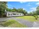Charming single story home with grey siding, black shutters and well maintained front lawn at 3284 Sassy Dr, Johns Island, SC 29455