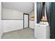 Cozy laundry area featuring a modern washing machine, wainscoting, neutral carpet, and convenient access to the exterior at 3284 Sassy Dr, Johns Island, SC 29455
