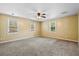 Bright and airy main bedroom with large windows, ceiling fan, neutral carpet, and natural light at 3284 Sassy Dr, Johns Island, SC 29455