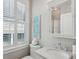 Bright bathroom features a large window with blinds and modern fixtures at 371 Bridgetown Pass, Mount Pleasant, SC 29464