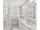 Bright bathroom features a glass-door shower, double vanity, and lots of natural light at 371 Bridgetown Pass, Mount Pleasant, SC 29464