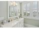 Bright bathroom with marble counters, white cabinets and plantation shutters at 371 Bridgetown Pass, Mount Pleasant, SC 29464