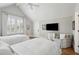 Cozy bedroom featuring two beds, neutral tones, and ample natural light from large windows at 371 Bridgetown Pass, Mount Pleasant, SC 29464