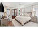 Bright bedroom with a king bed, French doors to a private porch, hardwood floors and a ceiling fan at 371 Bridgetown Pass, Mount Pleasant, SC 29464