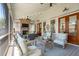 Comfortable seating area with a fireplace and ceiling fan on the covered patio at 371 Bridgetown Pass, Mount Pleasant, SC 29464