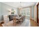 Dining room with a wooden table set, complemented by natural lighting, and elegant decor at 371 Bridgetown Pass, Mount Pleasant, SC 29464