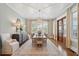 Formal dining room with a large table, statement chandelier, and access to outdoor space at 371 Bridgetown Pass, Mount Pleasant, SC 29464