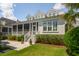 Back exterior view of home featuring a screened porch and lush backyard landscaping at 371 Bridgetown Pass, Mount Pleasant, SC 29464