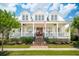 Charming two-story home with a brick staircase and a welcoming front porch beneath a bright blue, partly cloudy sky at 371 Bridgetown Pass, Mount Pleasant, SC 29464