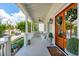 Inviting front porch with rocking chairs, a porch swing, and double doors adorned with wreaths at 371 Bridgetown Pass, Mount Pleasant, SC 29464