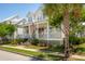 Inviting home featuring a classic American flag, a charming front porch, and lush, colorful landscaping at 371 Bridgetown Pass, Mount Pleasant, SC 29464