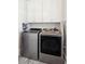 Laundry room with front load washer and dryer and white cabinets at 371 Bridgetown Pass, Mount Pleasant, SC 29464