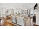 Open-concept living room featuring hardwood floors, a fireplace, and seamless flow to the kitchen at 371 Bridgetown Pass, Mount Pleasant, SC 29464