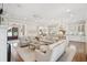 Bright living room with hardwood floors and elegant furnishings and an open layout to the kitchen at 371 Bridgetown Pass, Mount Pleasant, SC 29464