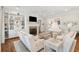 Bright living room featuring built-in shelves, a brick fireplace, and comfortable seating at 371 Bridgetown Pass, Mount Pleasant, SC 29464