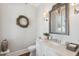 Charming powder room features a decorative mirror, marble countertop, and stylish fixtures at 371 Bridgetown Pass, Mount Pleasant, SC 29464