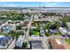 Aerial view of a neighborhood with colorful houses, lush trees, and the city's harbor in the background at 4 Line St, Charleston, SC 29403