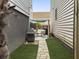 This backyard has a stone walkway leading to an outdoor entertaining space with a grill and seating at 4 Line St, Charleston, SC 29403
