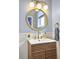 Updated bathroom with a unique vanity, stylish mirror, and modern lighting fixtures at 4 Line St, Charleston, SC 29403
