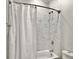 Bathroom with a shower, tub, and white marble tile at 4 Line St, Charleston, SC 29403