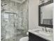 Bathroom with a tiled walk-in shower, marble countertop, and modern fixtures at 4 Line St, Charleston, SC 29403