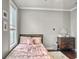 Bright bedroom featuring a bed with a pink cover, large window, and a dresser at 4 Line St, Charleston, SC 29403