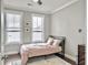 Bright bedroom featuring large windows, hardwood floors, and neutral tones at 4 Line St, Charleston, SC 29403