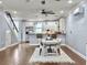 Bright and open dining area with modern furnishings, hardwood floors, and a clear view into the contemporary kitchen at 4 Line St, Charleston, SC 29403