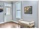 Inviting foyer featuring hardwood floors, a window with blinds, a stylish bench, and a decorative wall art piece at 4 Line St, Charleston, SC 29403