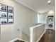 Hallway with hardwood floors, modern decor, and a convenient laundry area at 4 Line St, Charleston, SC 29403