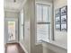 Bright hallway with natural light and wood floors leading to a door and balcony at 4 Line St, Charleston, SC 29403