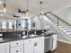 Modern kitchen view highlighting the breakfast bar and stairway to the second level at 4 Line St, Charleston, SC 29403