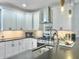 Well-lit kitchen featuring white cabinets, stainless steel appliances, and a stylish backsplash at 4 Line St, Charleston, SC 29403