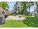 The backyard features a patio with an outdoor grill, seating, and a lush green lawn, perfect for entertaining at 402 Woodward Blvd, Summerville, SC 29483