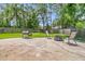 An outdoor patio with a grill, seating, and lush green grass provides a perfect space for relaxing and grilling outside at 402 Woodward Blvd, Summerville, SC 29483