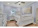 Bright bedroom showcases a four poster bed, white furniture, and natural light at 402 Woodward Blvd, Summerville, SC 29483